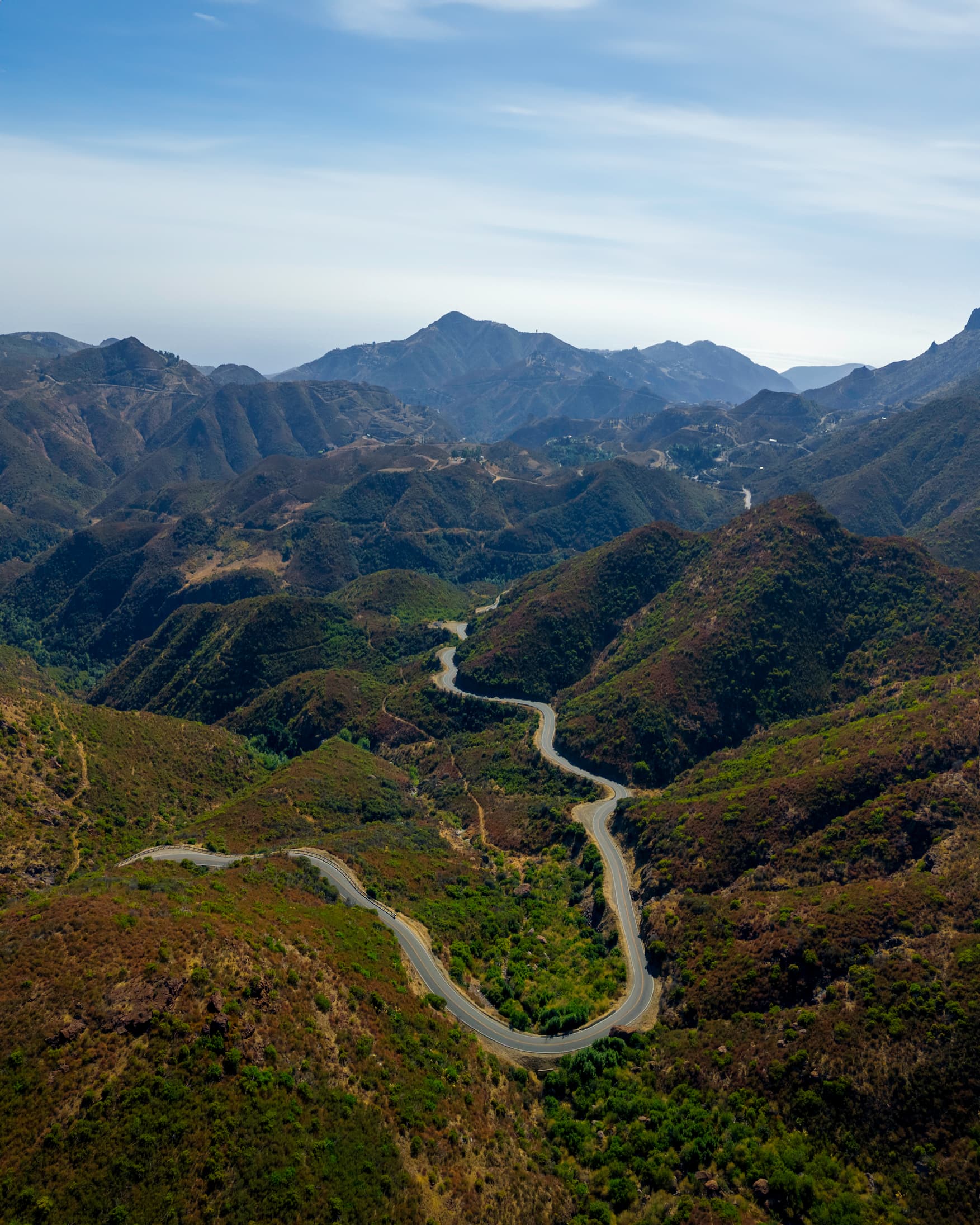 Aerial view of a winding road through the rugged Santa Monica Mountains.